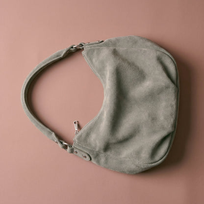 Gray handbag on a brown background