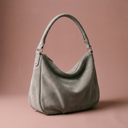 Gray handbag on a brown background