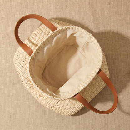 Woven bag with leather handles inside